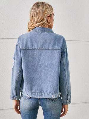 Light wash denim trucker jacket with distressed details and button cuffs.
