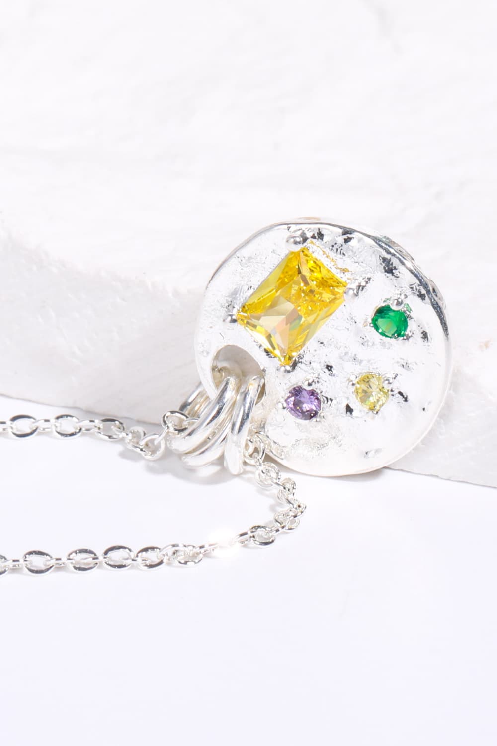 Silver textured disc pendant necklace with gemstone accents