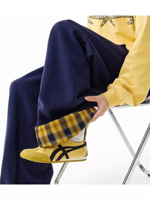 Navy wide-leg sweatpants with plaid cuff detail and drawstring.