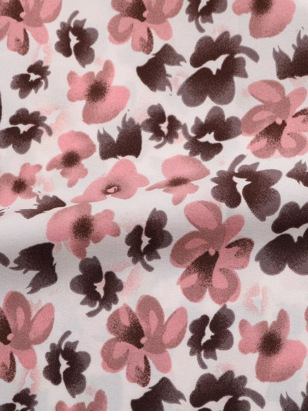 Shirt fabric with a pink and brown floral print on white.