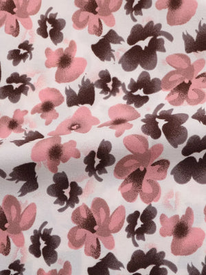 Shirt fabric with a pink and brown floral print on white.