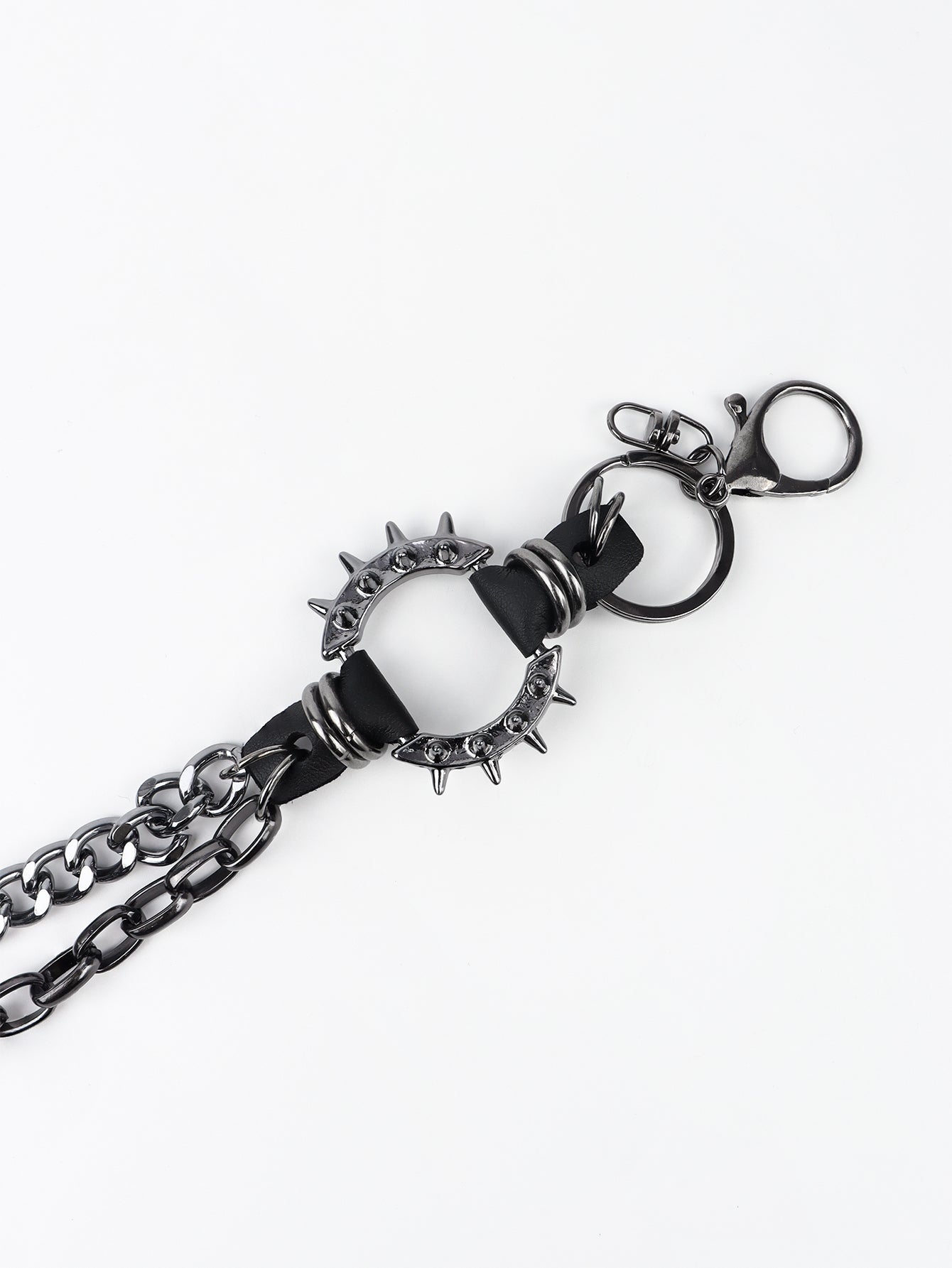 Black spiked chain harness belt with aluminum hardware and clasp.