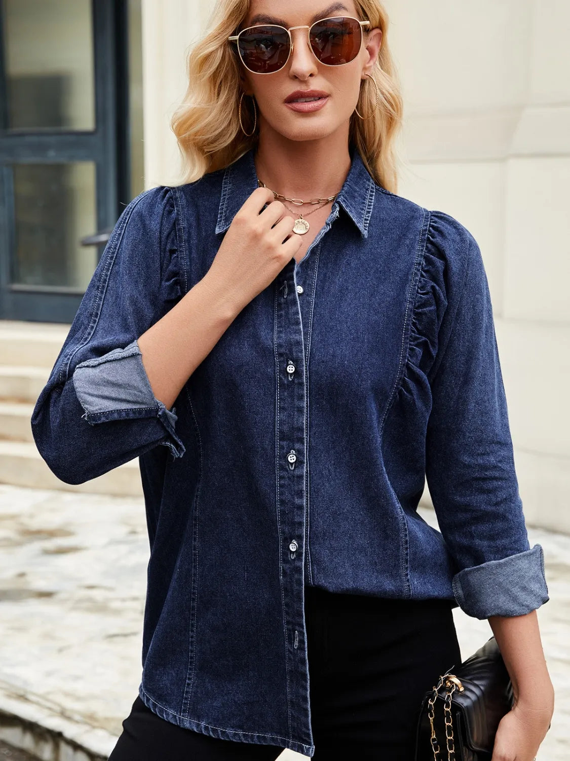 Dark blue denim blouse with ruffled puff sleeves and button front.