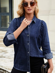 Dark blue denim blouse with ruffled puff sleeves and button front.