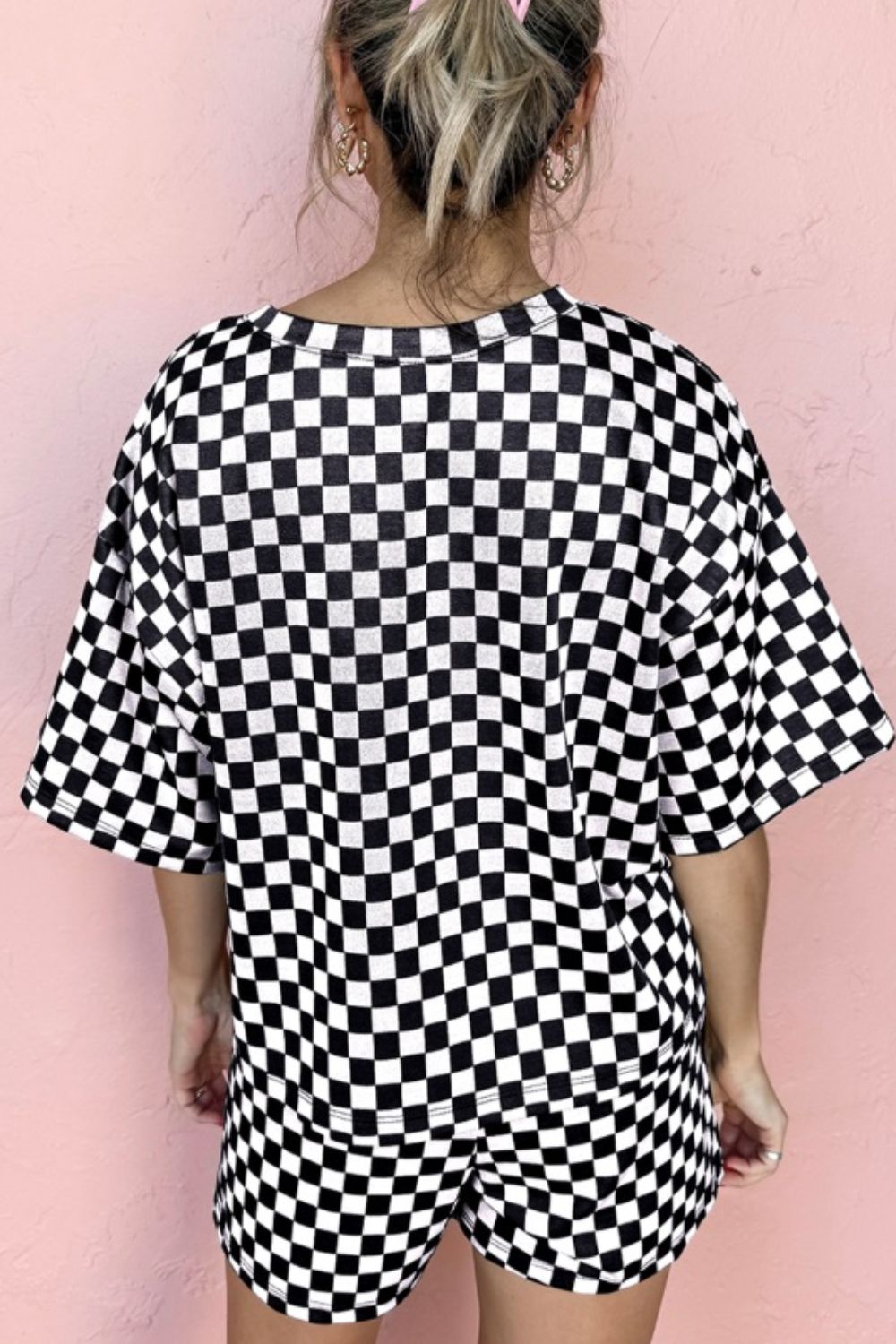 Black and white checkered loungewear set with short sleeves and shorts.