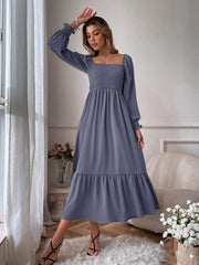 Smocked midi dress in dusty blue with square neck, puff sleeves, and tiered hem.