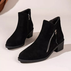 Black suede ankle boots with pointed toe, block heel, and side zipper detail.