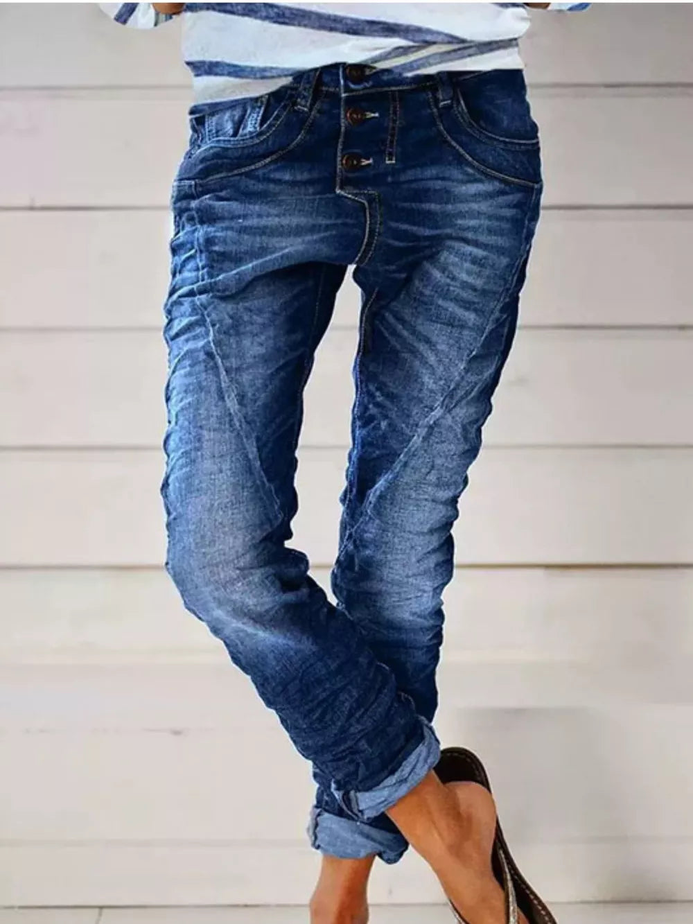 Dark blue cuffed button-fly jeans with ruched detailing and a relaxed fit.