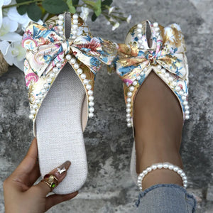 Floral bow pearl embellished slides with a floral pattern and pearl trim.