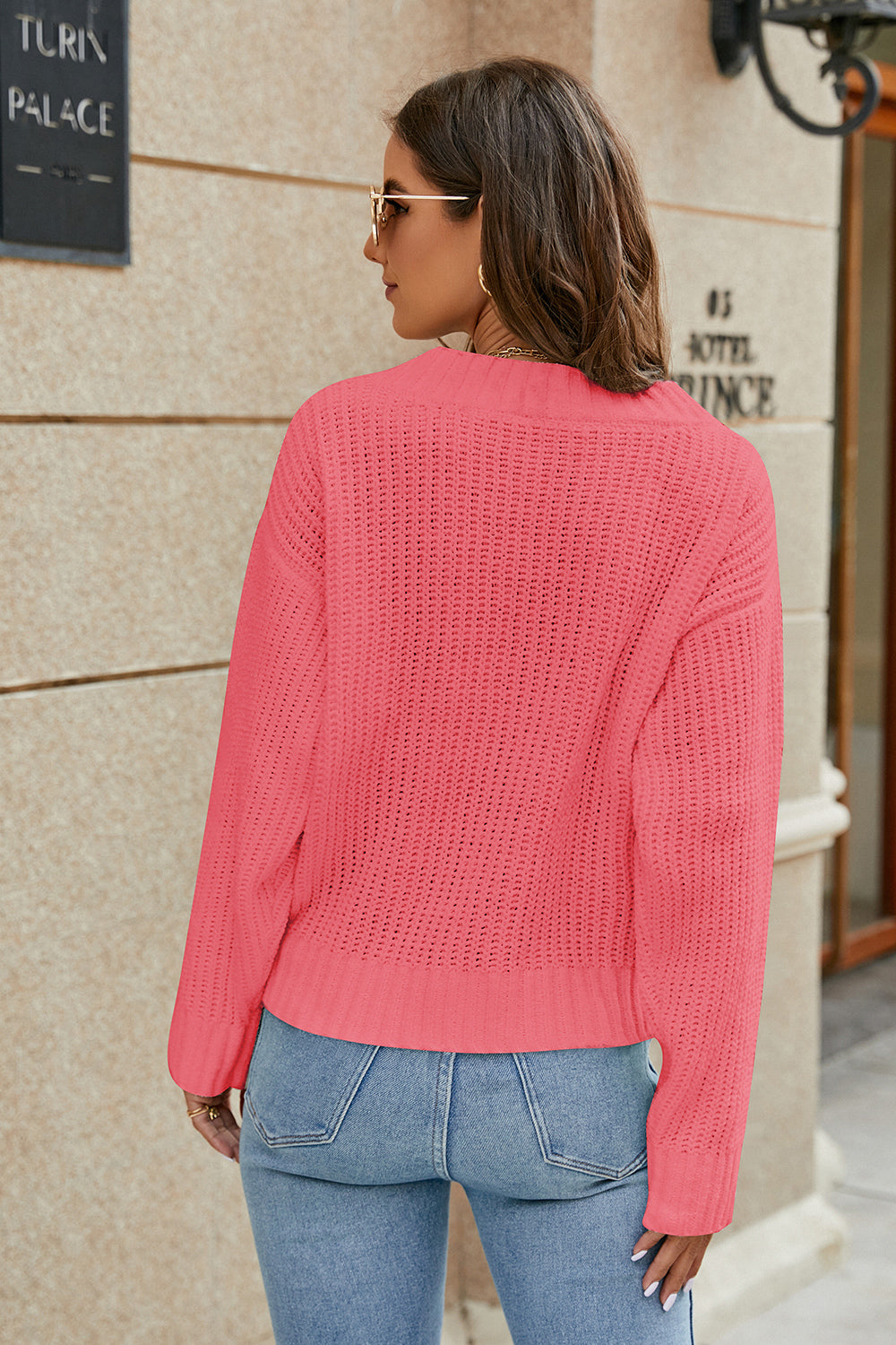 Cross-front ribbed knit sweater in strawberry with a relaxed fit and crew neck.