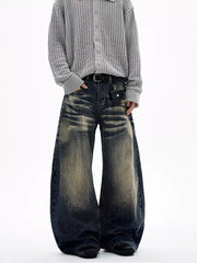 Men's vintage wash wide leg jeans in dark denim with distressed details and a belted waist.
