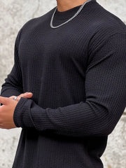 Men's black long sleeve textured tee with round neck.