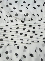 Charming Ruched Halter Neck Mini Dress in white with black polka dots and ruched detail.