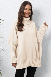 Beige ribbed turtleneck sweater with batwing sleeves and textured cuffs.