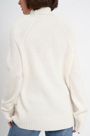 White cashmere turtleneck sweater with raglan sleeves and ribbed cuffs and hem.