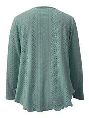 Light blue eyelet blouse with scalloped hem and long sleeves.