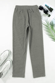 Corduroy drawstring trousers in dark gray with a relaxed fit and slant pockets.
