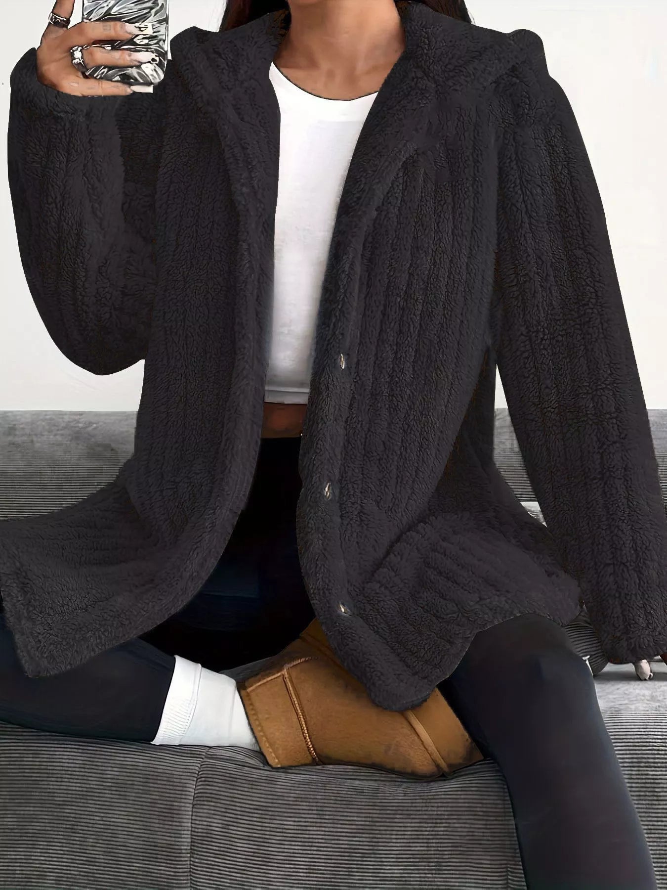 Black button-up fleece jacket with a textured pattern and cozy fit.