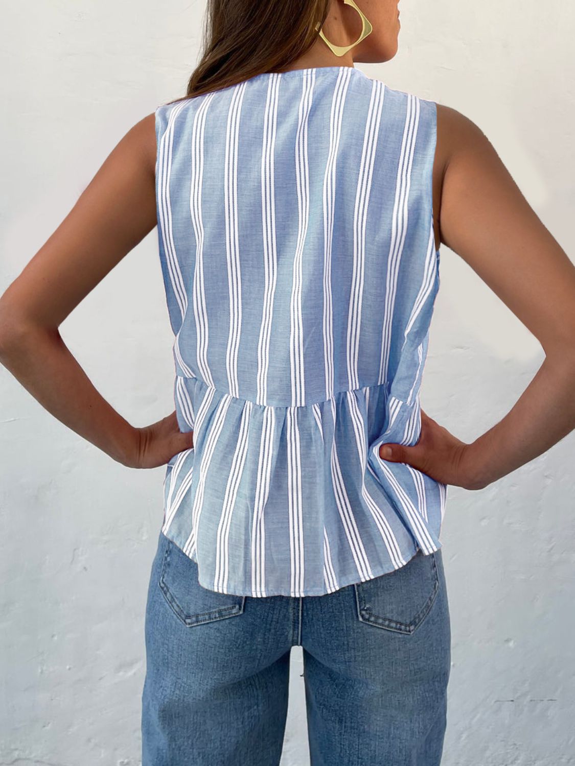 Light blue and white striped peplum blouse with a bow-tie back detail.