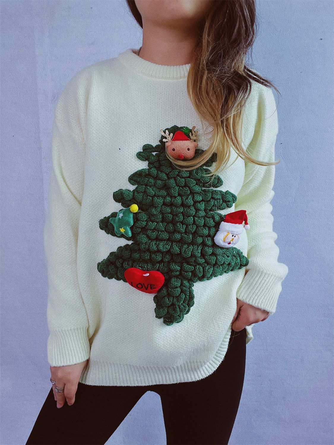 White acrylic knit sweater with a 3D Christmas tree applique, reindeer, snowman, and heart detail.