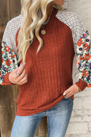 Terracotta ribbed knit top with floral print and lace sleeves.