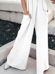 White smocked pocketed wide leg romper with pockets and a relaxed fit.