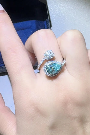 Bypass ring with turquoise pear-cut moissanite and diamond halo.