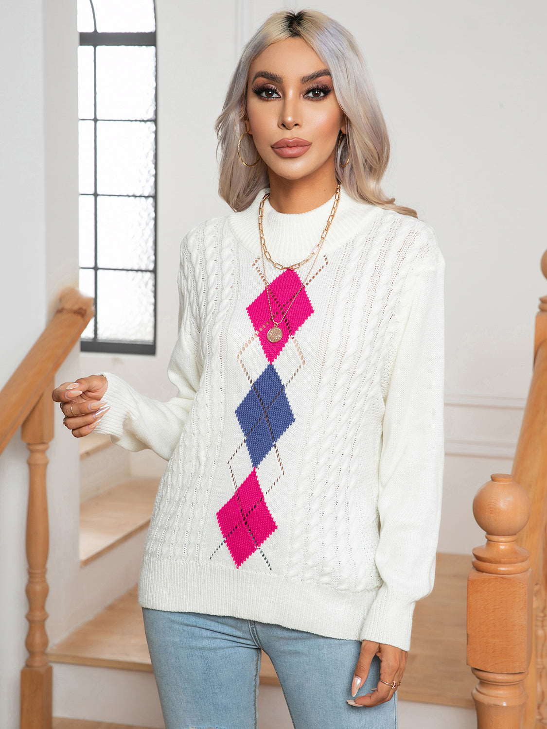 White argyle cable-knit mock neck sweater with pink and blue diamonds