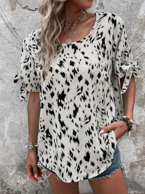 Dalmatian print blouse with bow sleeves and boatneck in cream and black.