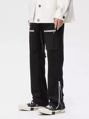 Black relaxed fit sweatpants with zipper pockets and ankle zippers.