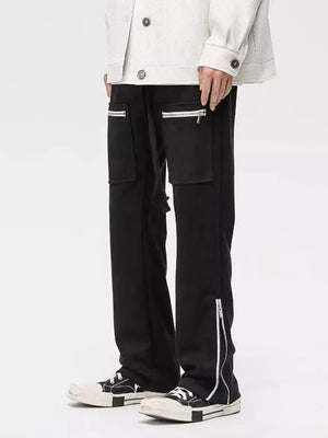 Black relaxed fit sweatpants with zipper pockets and ankle zippers.