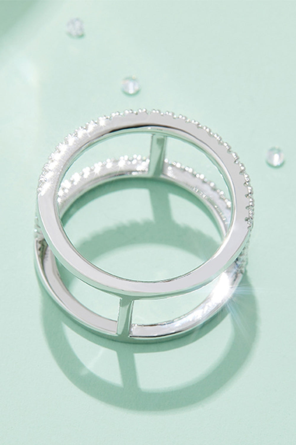 Silver geometric pave moissanite statement ring with double band design.