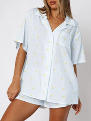 Light blue striped pajama set with yellow floral print, collared button-up shirt and shorts.