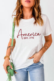 White t-shirt with "America EST. 1776" graphic in burgundy script.