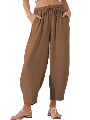 Brown balloon trousers with drawstring waist and sculpted seam detail.