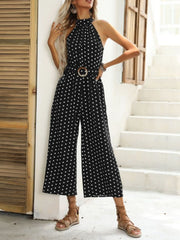 Black polka dot halter romper with wide legs and a belted waist.