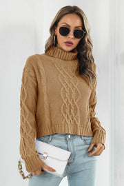 Camel cable knit cropped turtleneck sweater with braided detail and ribbed cuffs.