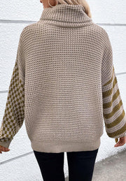Mocha knit turtleneck sweater with checkerboard and stripe sleeves.