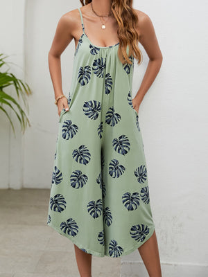 Sage culotte jumpsuit with monstera print and gathered bust detail.