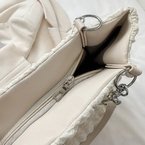 Textured grid pearl chain tote in ivory with a ruffled edge detail and silver hardware.