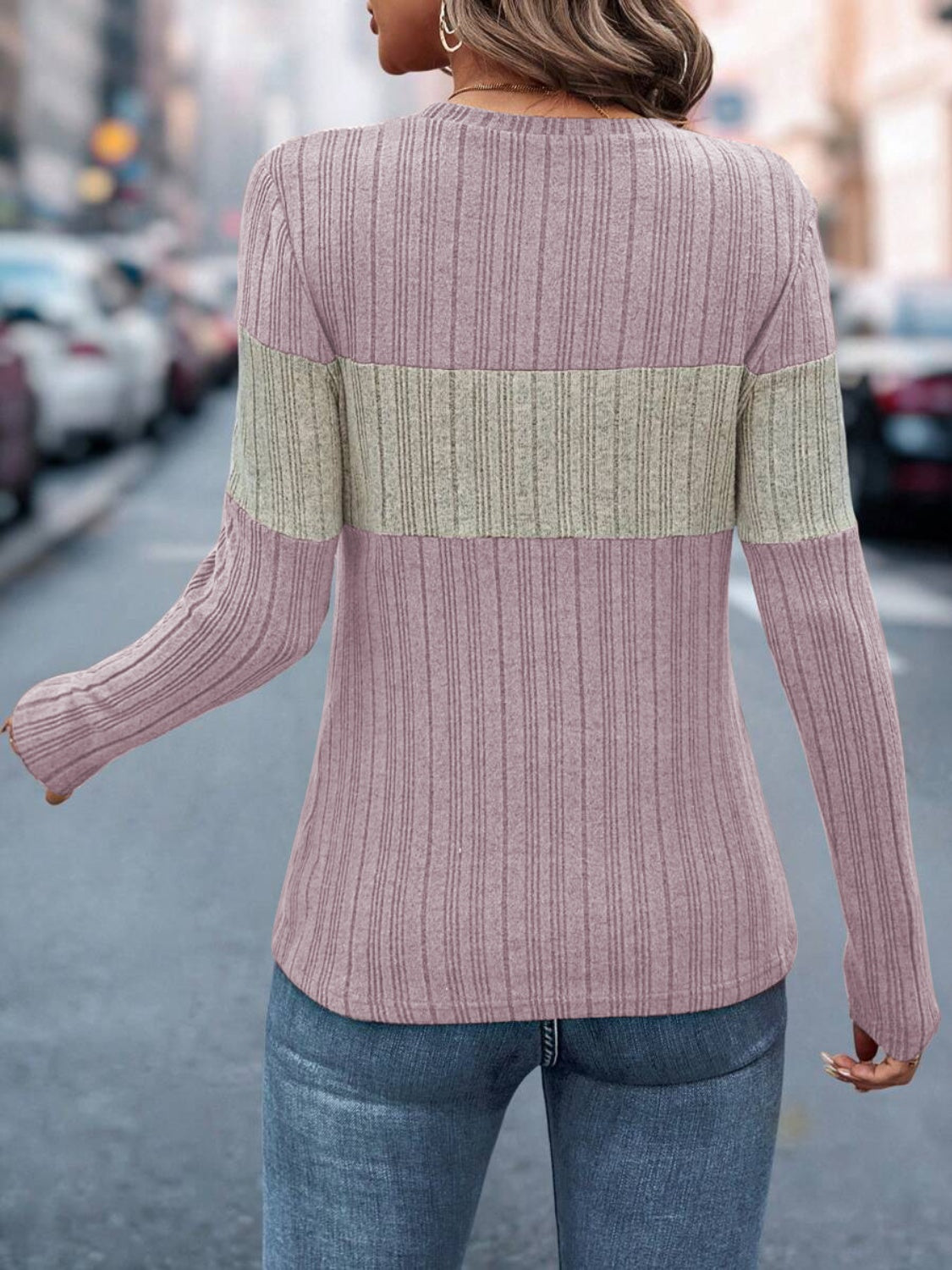 Ribbed crewneck sweater in pink with a beige colorblock stripe.
