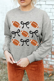 Gray sweatshirt with footballs and black bows graphic print