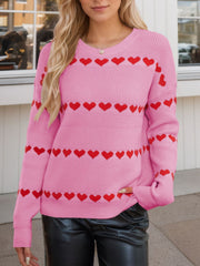 Pink knit sweater with red heart stripes, crew neck, long sleeves.