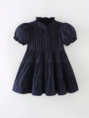 Navy cotton blend toddler dress with ruffle collar, puff sleeves, and tiered skirt.