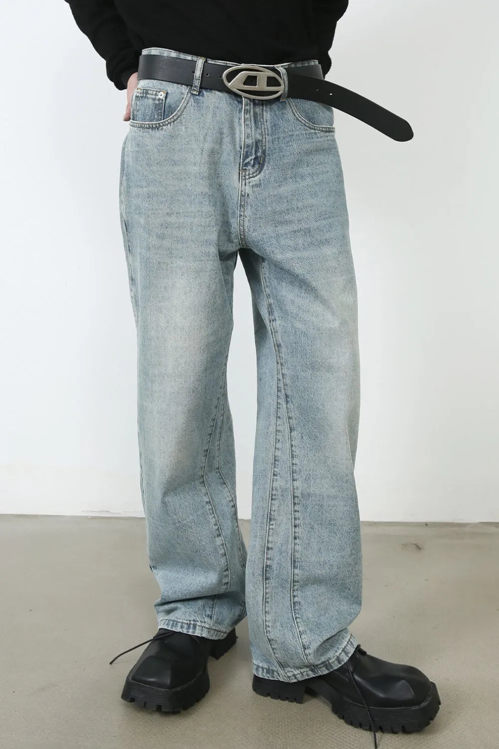 Wide-leg denim jeans in medium wash with subtle seam detail down the leg.