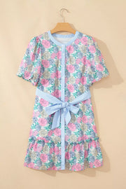Floral mini dress with contrast trim, button front, puff sleeves, and belted waist.