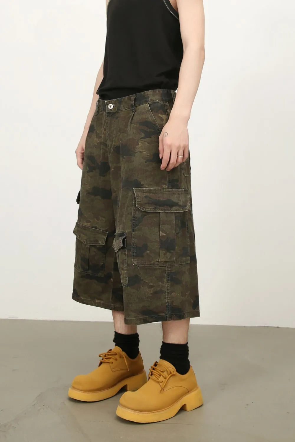 Camo culotte cargo shorts in green camouflage with multiple pockets.