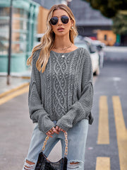 Charcoal cable-knit sweater with a boat neck and textured sleeves.
