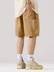 Khaki 100 cotton relaxed fit cargo shorts with adjustable drawstring and side pocket detail.