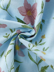 Light blue ribbed knit baby dress with a floral print and ruffled details.